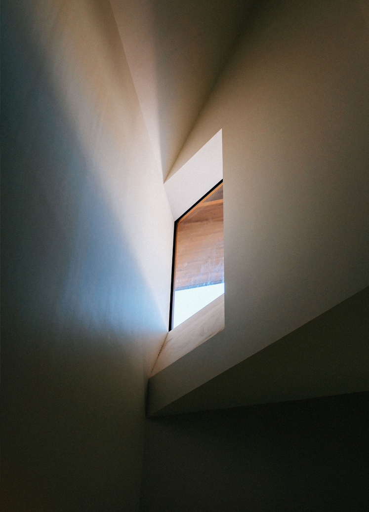 Light entering through an angular opening in a modern interior