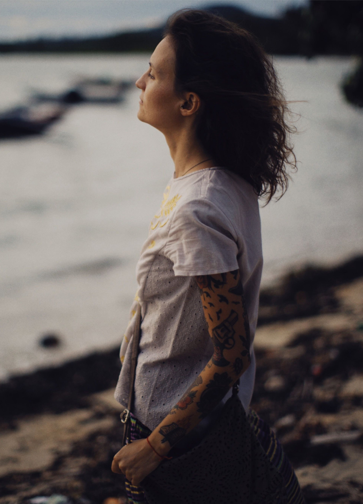 Woman standing quietly by the water