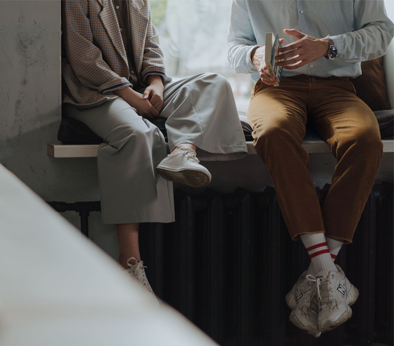 Two people sitting together and having a conversation